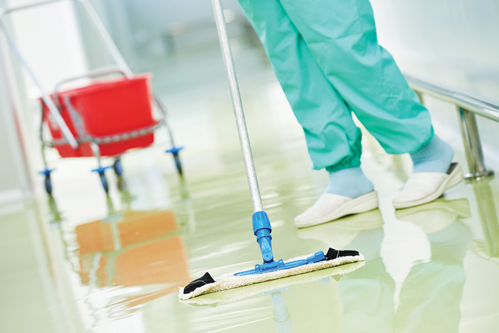 What type of personal protective equipment (PPE) is necessary when cleaning instruments and surfaces?
